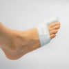 Foot with a bunion corrector on a plain background